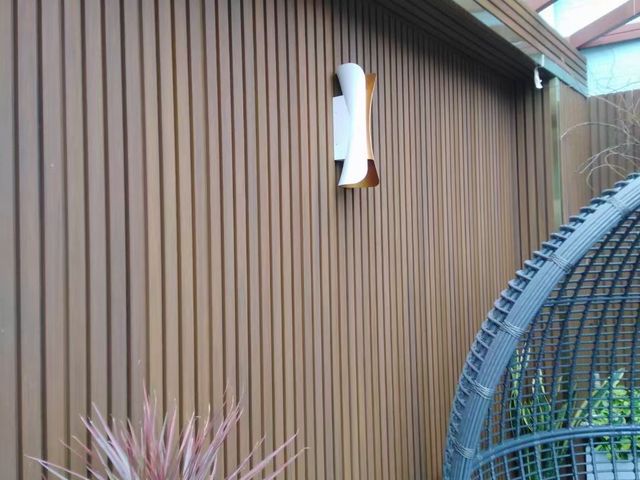 Dark fluted cladding feature wall behind an outdoor chair