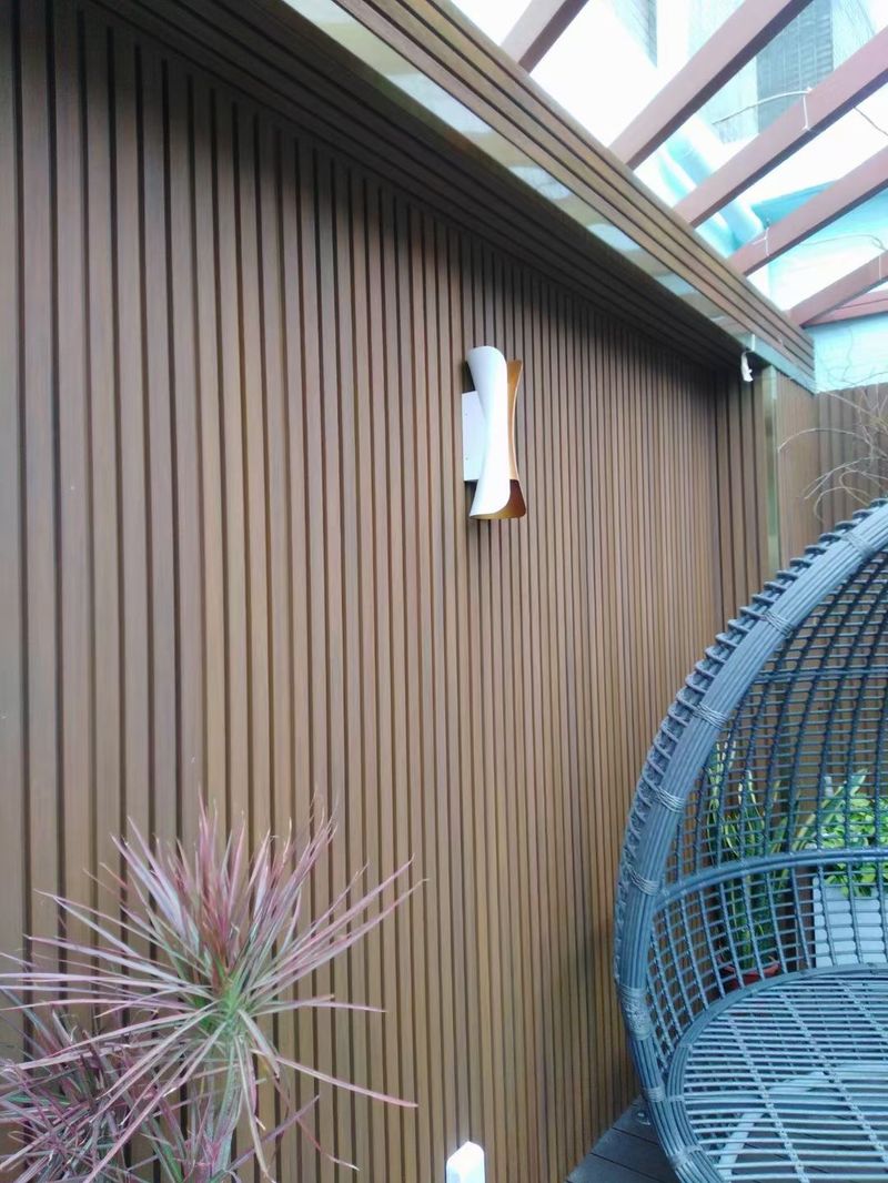 Dark slat cladding feature wall in an outdoor lounge corner